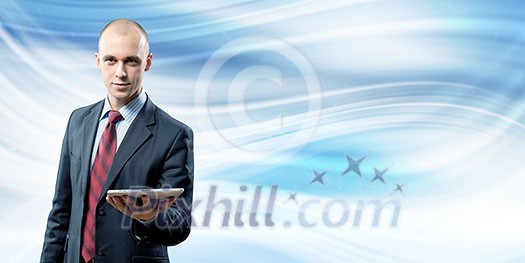 Young handsome businessman holding tablet pc in hand Young handsome businessman holding tablet pc in hand
