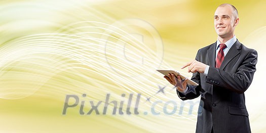 Young handsome businessman holding tablet pc in hand Young handsome businessman holding tablet pc in hand