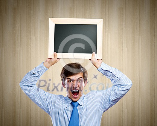 Handsome businessman holding blank frame. Place for text