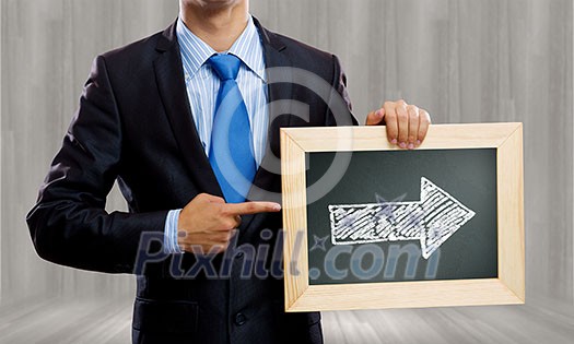 Close up of businessman holding frame with business sketch Close up of businessman holding frame with business sketch