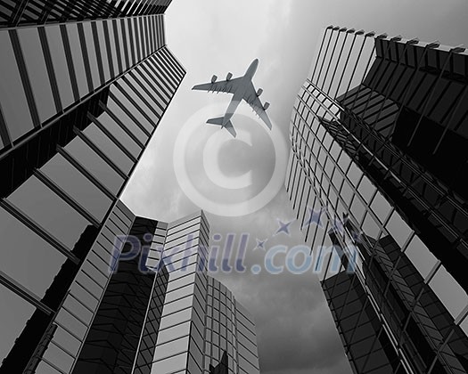 Bottom view of airplane flying above skyscrapers Bottom view of airplane flying above skyscrapers