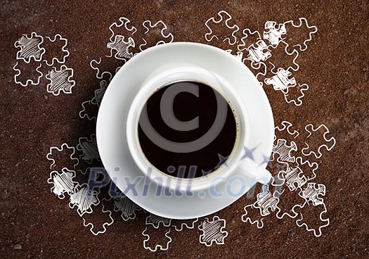 Close up of cup of coffee on table with sketches on background Close up of cup of coffee on table with sketches on background