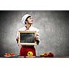 Handsome cook holding blank chalk board. Place for text