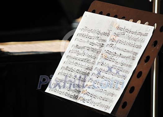 music book with letters at orchestra concert