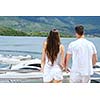 Romantic young couple spending time together and relaxing on yacht