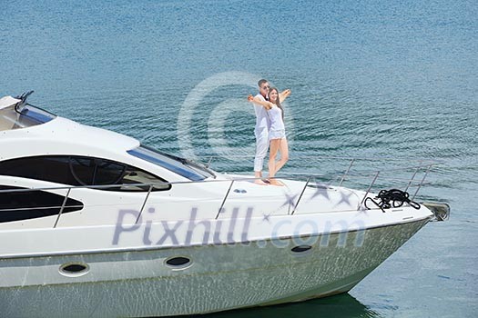 Romantic young couple spending time together and relaxing on yacht