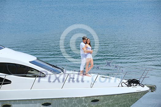 Romantic young couple spending time together and relaxing on yacht