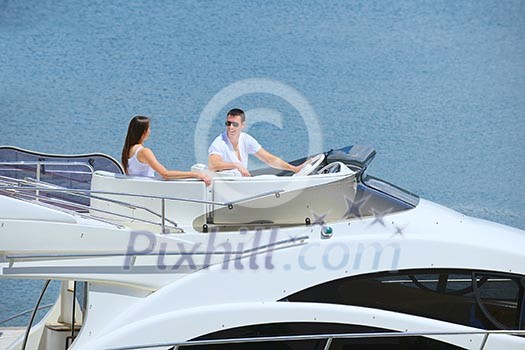 Romantic young couple spending time together and relaxing on yacht Romantic young couple spending time together and relaxing on yacht