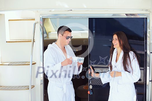 Romantic young couple spending time together and relaxing on yacht Romantic young couple spending time together and relaxing on yacht