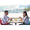 happy young couple having lanch at beautiful restaurant on the beach