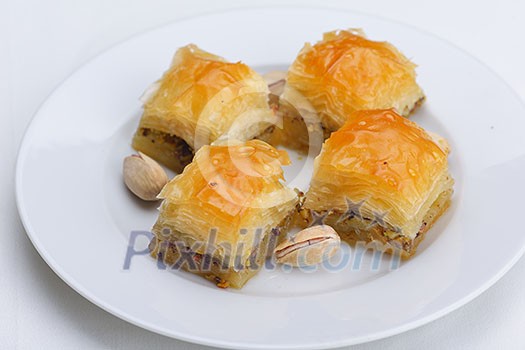 traditional dessert turkish baklava,well known in middle east and delicious isolated on white background traditional dessert turkish baklava,well known in middle east and delicious isolated on white background