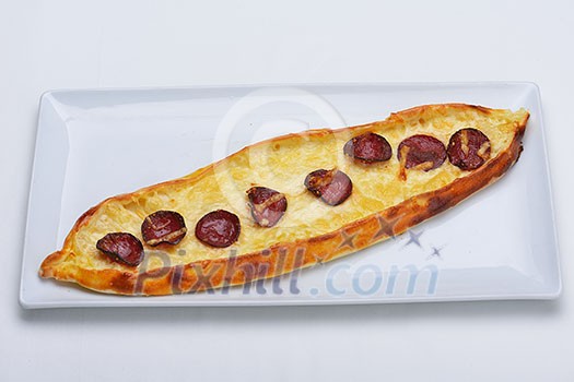 Homemade traditional Turkish meal pide stuffed with meat cheese,  and sauce isolated on white background