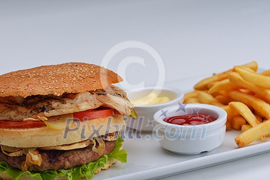 still life with fast food hamburger menu, french fries, soft drink and ketchup still life with fast food hamburger menu, french fries, soft drink and ketchup