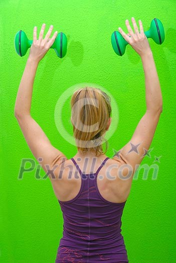 pretty woman with dumbbell