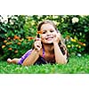 happy young girl children relax lie and have fun on grass with flower