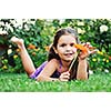 happy young girl children relax lie and have fun on grass with flower