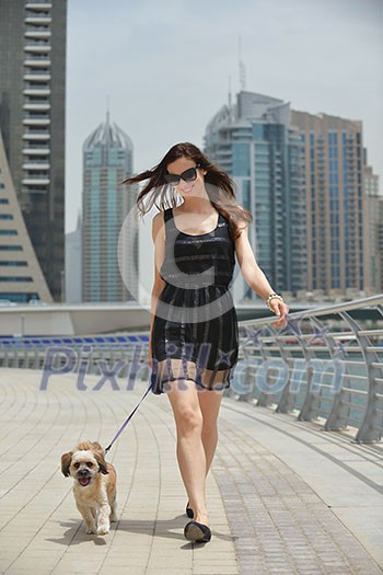 beautiful happy young woman in black dress with cute small dog puppy have fun on street beautiful happy young woman in black dress with cute small dog puppy have fun on street