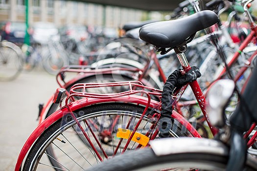 Bike rental service - Many bikes standing in bike stands, available for rent as a great mean of transport in the city Bike rental service - Many bikes standing in bike stands, available for rent as a great mean of transport in the city