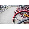 Bike rental service - Many bikes standing in bike stands, available for rent as a great mean of transport in the city