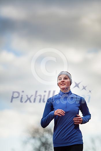 Portrait of a woman running against against blue sky