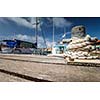 Boat docking point at a marina - rope fixed around a belay in a small harbor