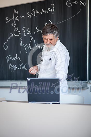 Senior chemistry professor writing on the board while having a chalk and blackboard lecture (shallow DOF; color toned image)