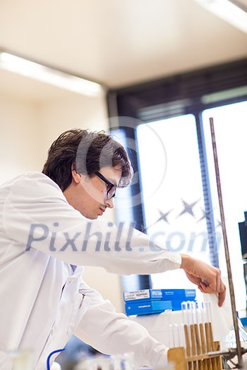 Male researcher carrying out scientific research in a lab (shallow DOF; color toned image) Male researcher carrying out scientific research in a lab (shallow DOF; color toned image)