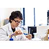 Male researcher carrying out scientific research in a lab (shallow DOF; color toned image)
