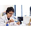 Male researcher carrying out scientific research in a lab (shallow DOF; color toned image)