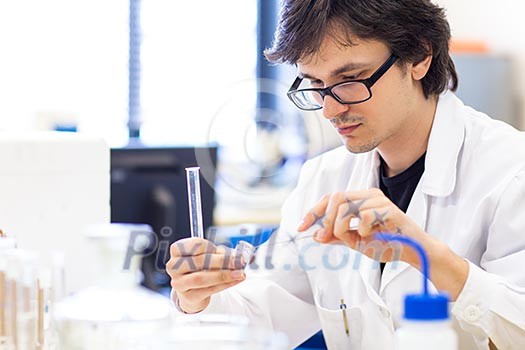 Male researcher carrying out scientific research in a lab (shallow DOF; color toned image) Male researcher carrying out scientific research in a lab (shallow DOF; color toned image)