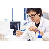 Male researcher carrying out scientific research in a lab (shallow DOF; color toned image)