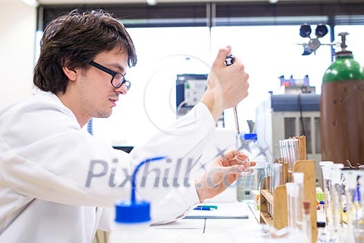Male researcher carrying out scientific research in a lab (shallow DOF; color toned image) Male researcher carrying out scientific research in a lab (shallow DOF; color toned image)