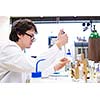 Male researcher carrying out scientific research in a lab (shallow DOF; color toned image)