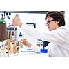 Male researcher carrying out scientific research in a lab (shallow DOF; color toned image)