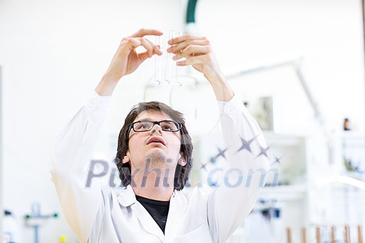 Male researcher carrying out scientific research in a lab (shallow DOF; color toned image) Male researcher carrying out scientific research in a lab (shallow DOF; color toned image)
