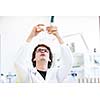 Male researcher carrying out scientific research in a lab (shallow DOF; color toned image)