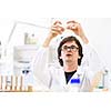 Male researcher carrying out scientific research in a lab (shallow DOF; color toned image)