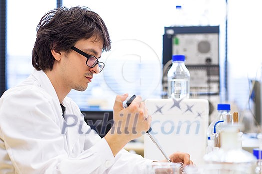 Male researcher carrying out scientific research in a lab (shallow DOF; color toned image) Male researcher carrying out scientific research in a lab (shallow DOF; color toned image)