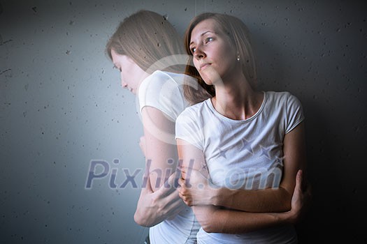 Young woman suffering from a severe depression/anxiety (color toned image; double exposure technique is used to convey the mood of unease, progression of the anxiety/depression)