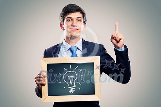 Handsome businessman holding wooden frame with words Handsome businessman holding wooden frame with words