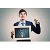 Handsome businessman holding wooden frame with words