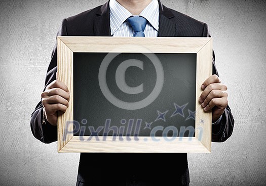 Close up of businessman holding blank frame. Place for text Close up of businessman holding blank frame. Place for text
