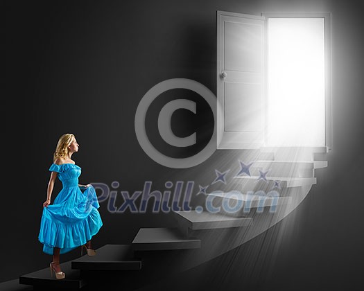 Young blond woman in blue dress walking up the stairs