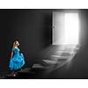 Young blond woman in blue dress walking up the stairs