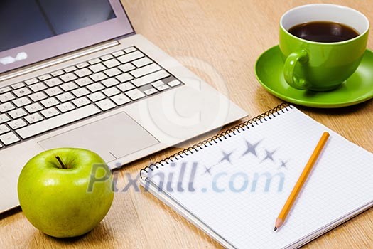 Tablet pc cup of coffee and notepad at table Tablet pc cup of coffee and notepad at table