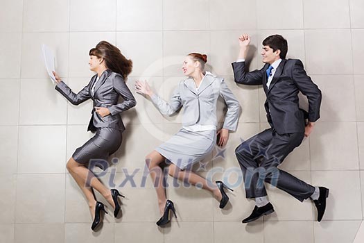 Young people in business suits lying on floor