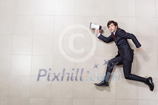 Funny image of running businessman holding megaphone Funny image of running businessman holding megaphone