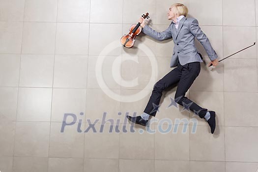 Funny image of running businessman with violin in hand