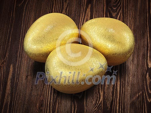 Three golden Easter eggs isolated on wooden background