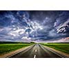 Travel concept background - road and stormy dramatic sky